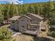 This two-story home features an expansive deck and a multi-car garage at 8724 Armadillo Trl, Evergreen, CO 80439