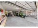 Spacious garage with ample storage space, high ceilings, and a large door at 8724 Armadillo Trl, Evergreen, CO 80439