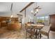 Open-concept kitchen and dining area with vaulted ceilings and scenic views from oversized windows at 8724 Armadillo Trl, Evergreen, CO 80439