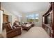 Bright living room featuring a large window with mountain views and cozy leather furniture at 8724 Armadillo Trl, Evergreen, CO 80439
