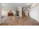 Open-concept living room featuring a stone fireplace, piano, and staircase with tile flooring throughout at 8724 Armadillo Trl, Evergreen, CO 80439