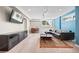 Modern living room with a dark sofa, area rug, and large television at 8724 Armadillo Trl, Evergreen, CO 80439