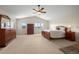 Large main bedroom with wooden furniture, carpet, and views of the mountains at 8724 Armadillo Trl, Evergreen, CO 80439