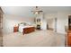 Spacious bedroom featuring a fireplace, and wooden furniture at 8724 Armadillo Trl, Evergreen, CO 80439