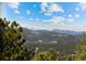 Stunning mountain views of snow capped peaks with a clear blue sky at 8724 Armadillo Trl, Evergreen, CO 80439