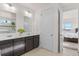 Double vanity bathroom with modern finishes and views of bedroom at 15740 Spruce St, Thornton, CO 80602