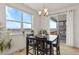 Bright dining area with table and chairs, and sliding door to balcony at 15740 Spruce St, Thornton, CO 80602