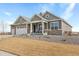 Two-story house with gray siding, stone accents, and a two-car garage at 15740 Spruce St, Thornton, CO 80602