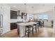 Modern kitchen with dark cabinets, white countertops, and an island at 15740 Spruce St, Thornton, CO 80602