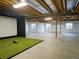 Spacious unfinished basement area, framed and ready for customization with a golf simulator at 609 Pioneer Camp Vw, Palmer Lake, CO 80133