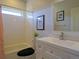 Bright bathroom featuring a white vanity, a toilet, and a shower with white subway tiles at 609 Pioneer Camp Vw, Palmer Lake, CO 80133