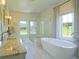 Luxurious bathroom features a standalone tub, double vanity, and glass shower at 609 Pioneer Camp Vw, Palmer Lake, CO 80133
