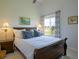 Bright bedroom featuring a large window with views, neutral walls, and a cozy queen-sized bed at 609 Pioneer Camp Vw, Palmer Lake, CO 80133