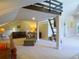 Open bonus room featuring neutral carpet, natural light, and a unique sleeping loft accessible by ladder at 609 Pioneer Camp Vw, Palmer Lake, CO 80133