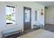 Bright entryway with a glass door, hardwood floors, bench seating, and neutral decor at 609 Pioneer Camp Vw, Palmer Lake, CO 80133