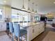 Bright kitchen boasts island seating, modern appliances, and an open layout flowing into living spaces at 609 Pioneer Camp Vw, Palmer Lake, CO 80133