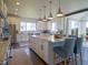 Open kitchen with a large center island, pendant lighting, stainless steel appliances, and white cabinetry at 609 Pioneer Camp Vw, Palmer Lake, CO 80133