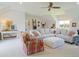 Spacious living room featuring a large sectional sofa, a ceiling fan, and lots of natural light at 609 Pioneer Camp Vw, Palmer Lake, CO 80133