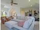 Airy living room featuring a large sectional sofa, a ceiling fan, and neutral tones at 609 Pioneer Camp Vw, Palmer Lake, CO 80133