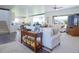 Open-concept living space with hardwood floors, neutral tones, and seamless flow to other living areas at 609 Pioneer Camp Vw, Palmer Lake, CO 80133