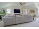 Bright living room with a gray sectional, large TV, and modern decor at 609 Pioneer Camp Vw, Palmer Lake, CO 80133
