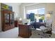 Spacious home office with custom built-ins and large window providing natural light at 609 Pioneer Camp Vw, Palmer Lake, CO 80133