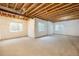 Spacious basement with carpet flooring, exposed ceiling, and multiple windows at 19096 W 53Rd Pl, Golden, CO 80403