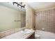 Cozy bathroom with tiled shower-tub, sink, and updated fixtures at 19096 W 53Rd Pl, Golden, CO 80403
