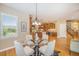 Dining room showcases modern chandelier, shuttered windows, and flows into kitchen at 19096 W 53Rd Pl, Golden, CO 80403
