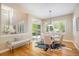 Bright dining room with modern chandelier, shuttered windows, and access to the backyard at 19096 W 53Rd Pl, Golden, CO 80403