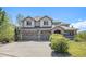 Beautiful two-story house with a stone facade, three-car garage, inviting front porch, and well-maintained landscaping at 19096 W 53Rd Pl, Golden, CO 80403