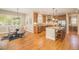 Open kitchen and dining area with hardwood floors, stainless steel appliances, and ample counter space with natural lighting at 19096 W 53Rd Pl, Golden, CO 80403