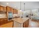 Open kitchen boasts wooden cabinets, stainless appliances, a granite island, and hardwood floors at 19096 W 53Rd Pl, Golden, CO 80403