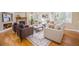 Elegant living room featuring hardwood floors, a stone fireplace, and comfortable seating with plenty of natural light at 19096 W 53Rd Pl, Golden, CO 80403