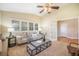 Living room with vaulted ceiling, large windows with shutters, and a ceiling fan at 19096 W 53Rd Pl, Golden, CO 80403