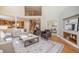 Spacious living room featuring high ceilings, hardwood floors, comfortable seating, and a view of the open floor plan at 19096 W 53Rd Pl, Golden, CO 80403