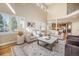 Bright living room with high ceilings, hardwood floors, comfortable seating, a large window, and modern decor at 19096 W 53Rd Pl, Golden, CO 80403