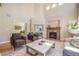 Inviting living room boasts hardwood floors, a stone fireplace, and comfortable seating with plenty of natural light at 19096 W 53Rd Pl, Golden, CO 80403