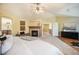 Serene primary bedroom with fireplace, sitting area, and seamless transition to the en-suite bathroom for ultimate convenience at 19096 W 53Rd Pl, Golden, CO 80403