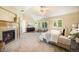 Spacious primary bedroom with fireplace, sitting area, and ample natural light creating a warm and inviting retreat at 19096 W 53Rd Pl, Golden, CO 80403