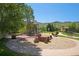 Community playground surrounded by mature trees and walking trails at 19096 W 53Rd Pl, Golden, CO 80403