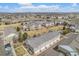 Aerial view of townhomes near a pond, showcasing green spaces and well-kept exteriors in a neighborhood setting at 12710 Jasmine St # C, Thornton, CO 80602