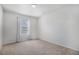 Bedroom with neutral carpeting, vertical blinds, and a window offering natural light at 12710 Jasmine St # C, Thornton, CO 80602