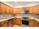 Modern kitchen with stainless steel appliances, updated countertops, and ample cabinet storage at 12710 Jasmine St # C, Thornton, CO 80602
