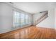 Bright living room featuring hardwood floors, large windows, and staircase access to the upper level at 12710 Jasmine St # C, Thornton, CO 80602