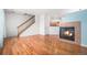 Inviting living room featuring hardwood floors, a cozy fireplace, and an open layout at 12710 Jasmine St # C, Thornton, CO 80602
