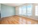 Light-filled living room with hardwood floors and large windows, providing ample natural light at 12710 Jasmine St # C, Thornton, CO 80602