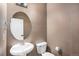 Convenient half-bathroom featuring a pedestal sink and toilet at 12710 Jasmine St # C, Thornton, CO 80602