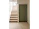 Carpeted basement stairs lead to a window letting in natural light with a storage closet at 4631 Zuni St, Denver, CO 80211