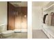 Bathroom with glass shower enclosure adjacent to closet with built-in shelving at 4631 Zuni St, Denver, CO 80211
